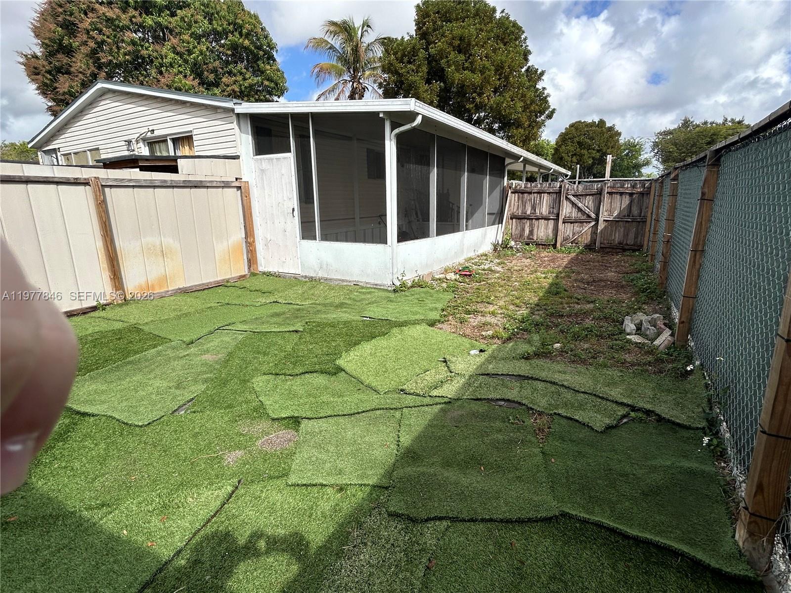 10467 South 228th Lane, Unit A Boca Raton, FL 33428 - Photo 27 of 27 a view of a back yard of the house