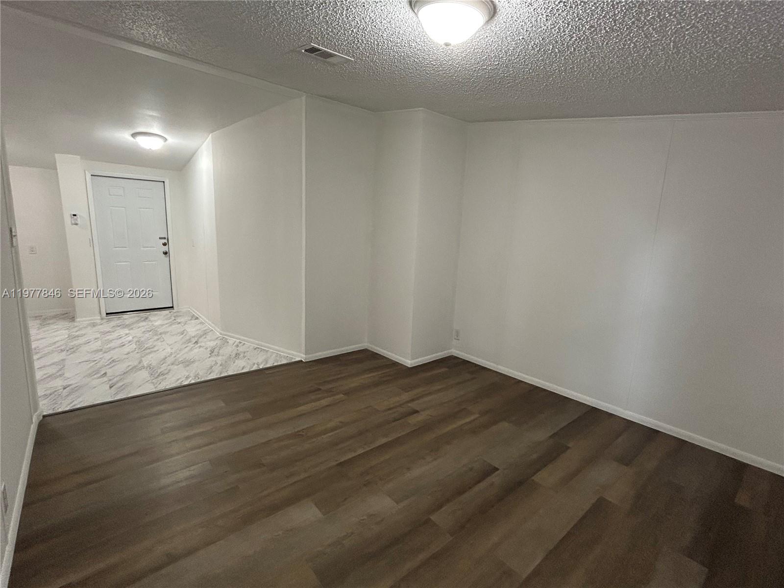 10467 South 228th Lane, Unit A Boca Raton, FL 33428 - Photo 8 of 27 a view of an empty room and wooden floor
