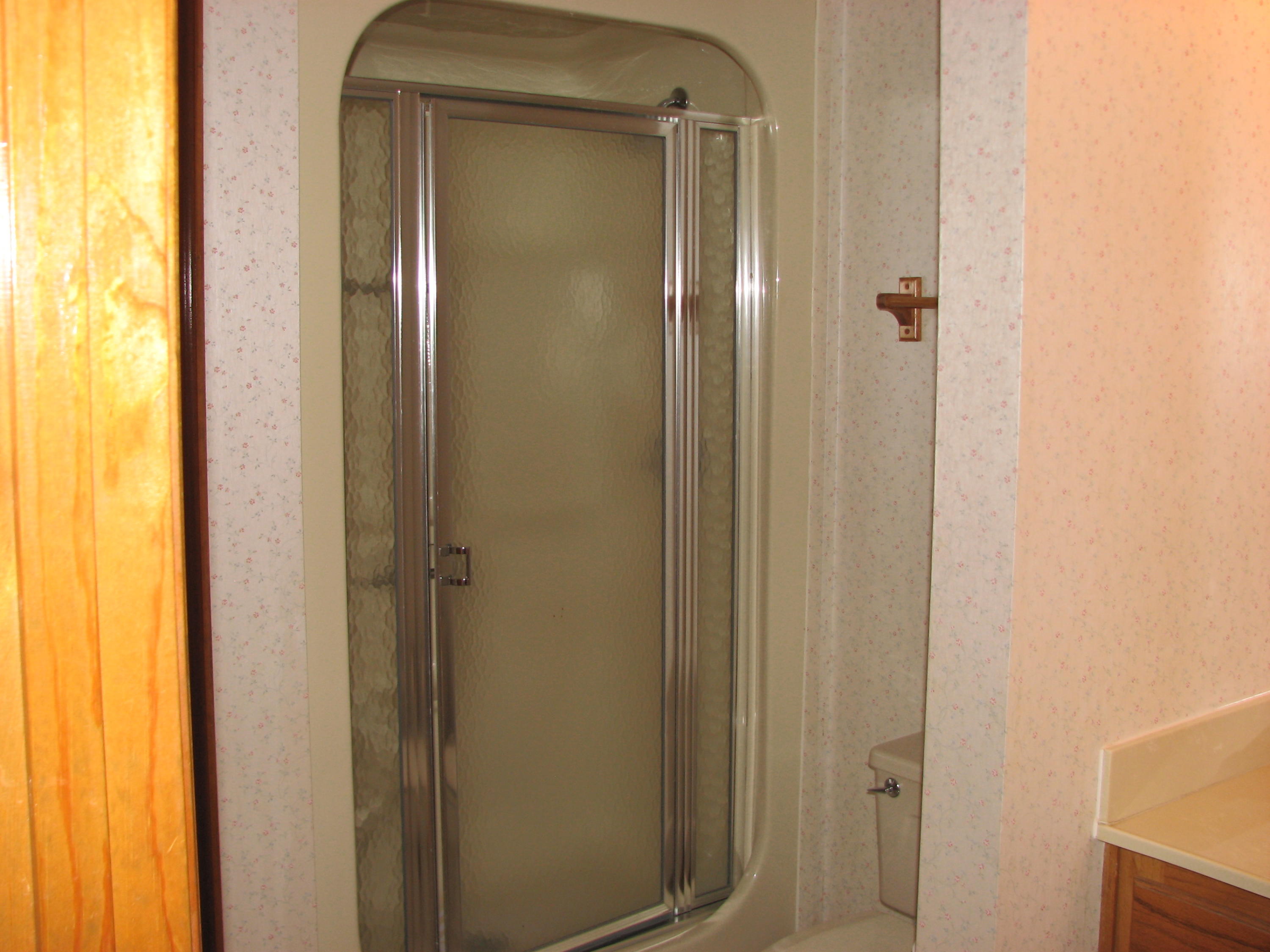 803 Melton Road Baker, FL 32531 - Photo 15 of 36 a bathroom with a glass door