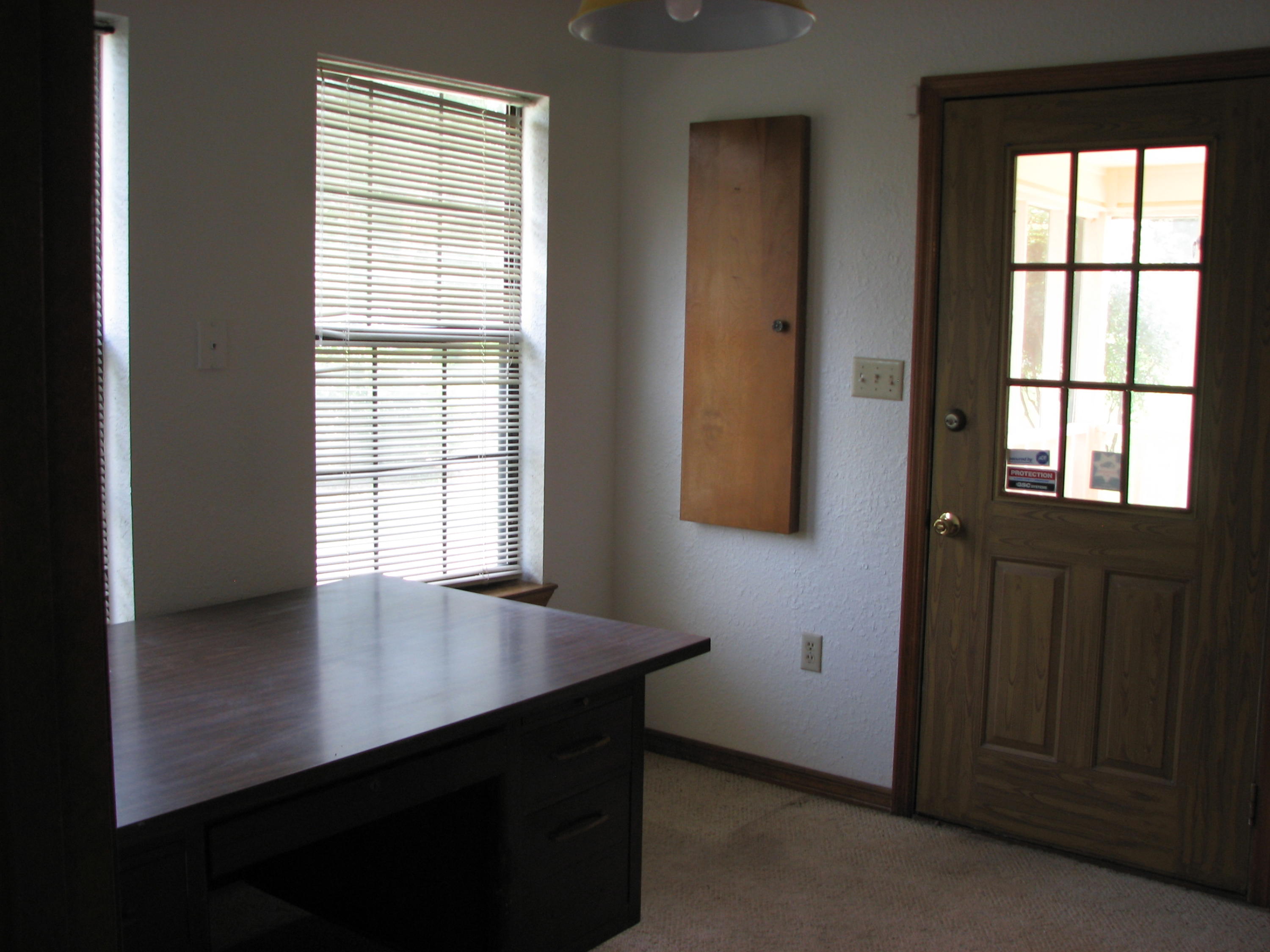 803 Melton Road Baker, FL 32531 - Photo 4 of 36 an empty room with wooden floor and windows