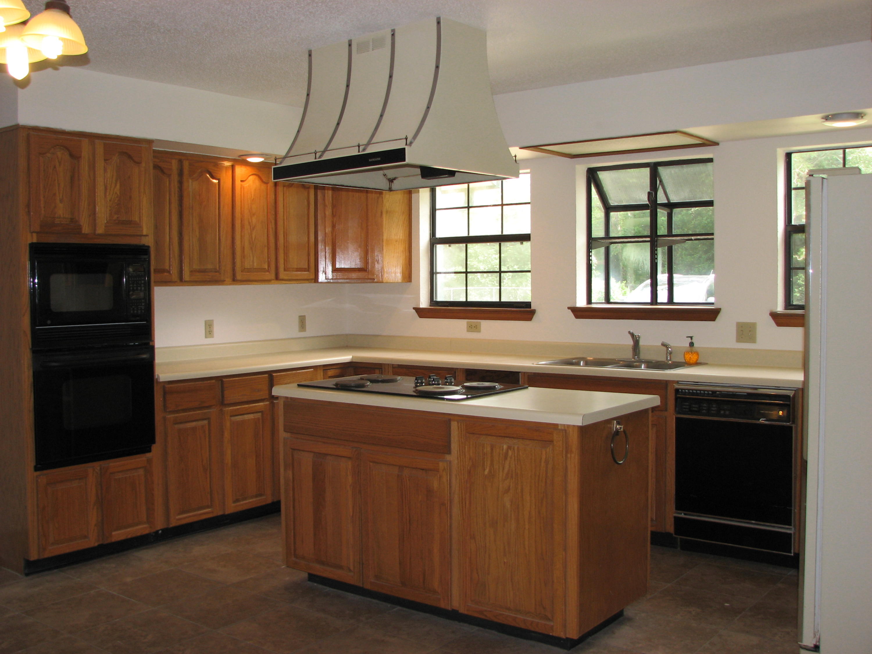 803 Melton Road Baker, FL 32531 - Photo 7 of 36 a kitchen with stainless steel appliances granite countertop a stove a sink and a refrigerator