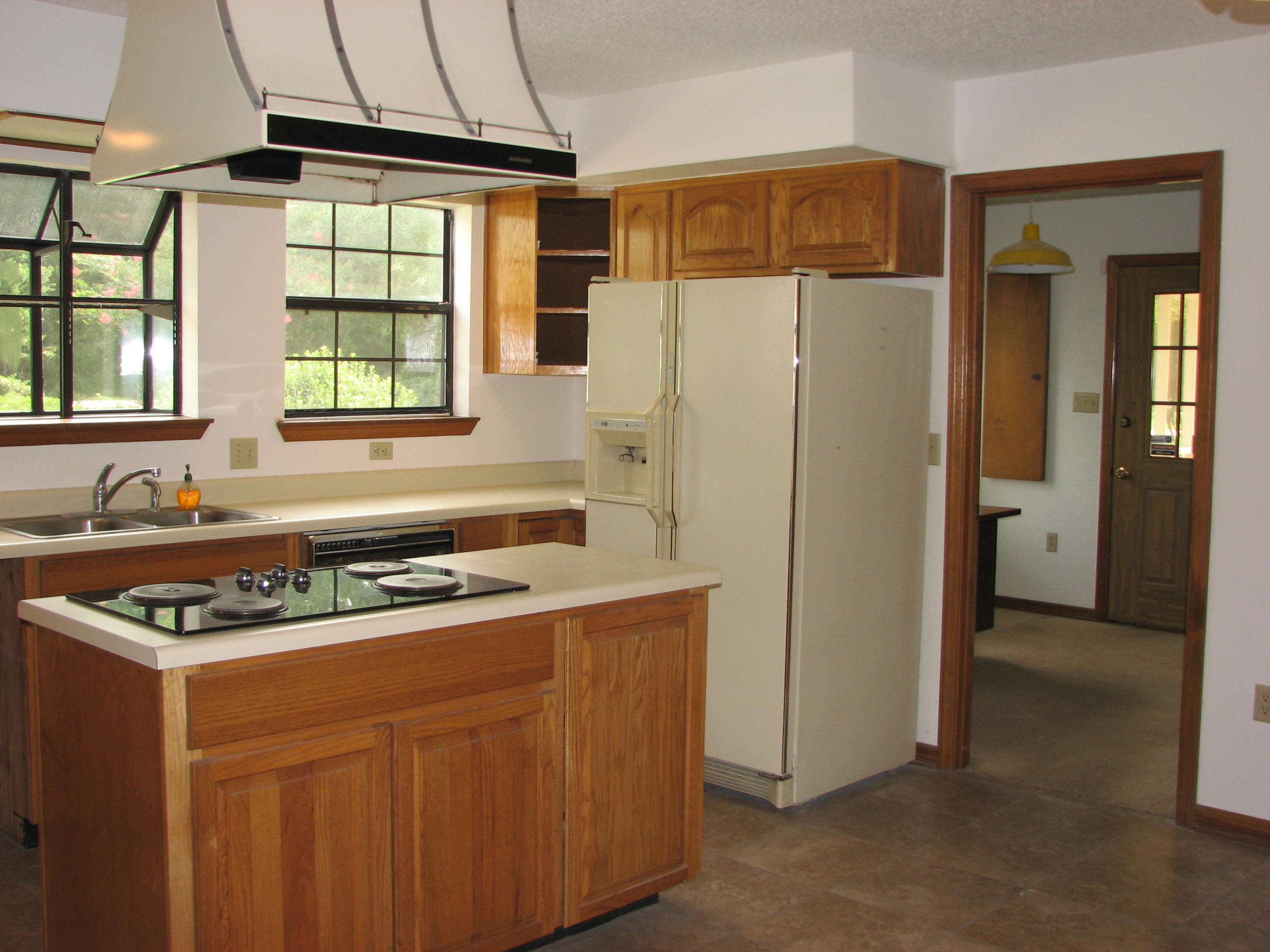 803 Melton Road Baker, FL 32531 - Photo 8 of 36 a kitchen with stainless steel appliances granite countertop a refrigerator a sink a stove and a refrigerator