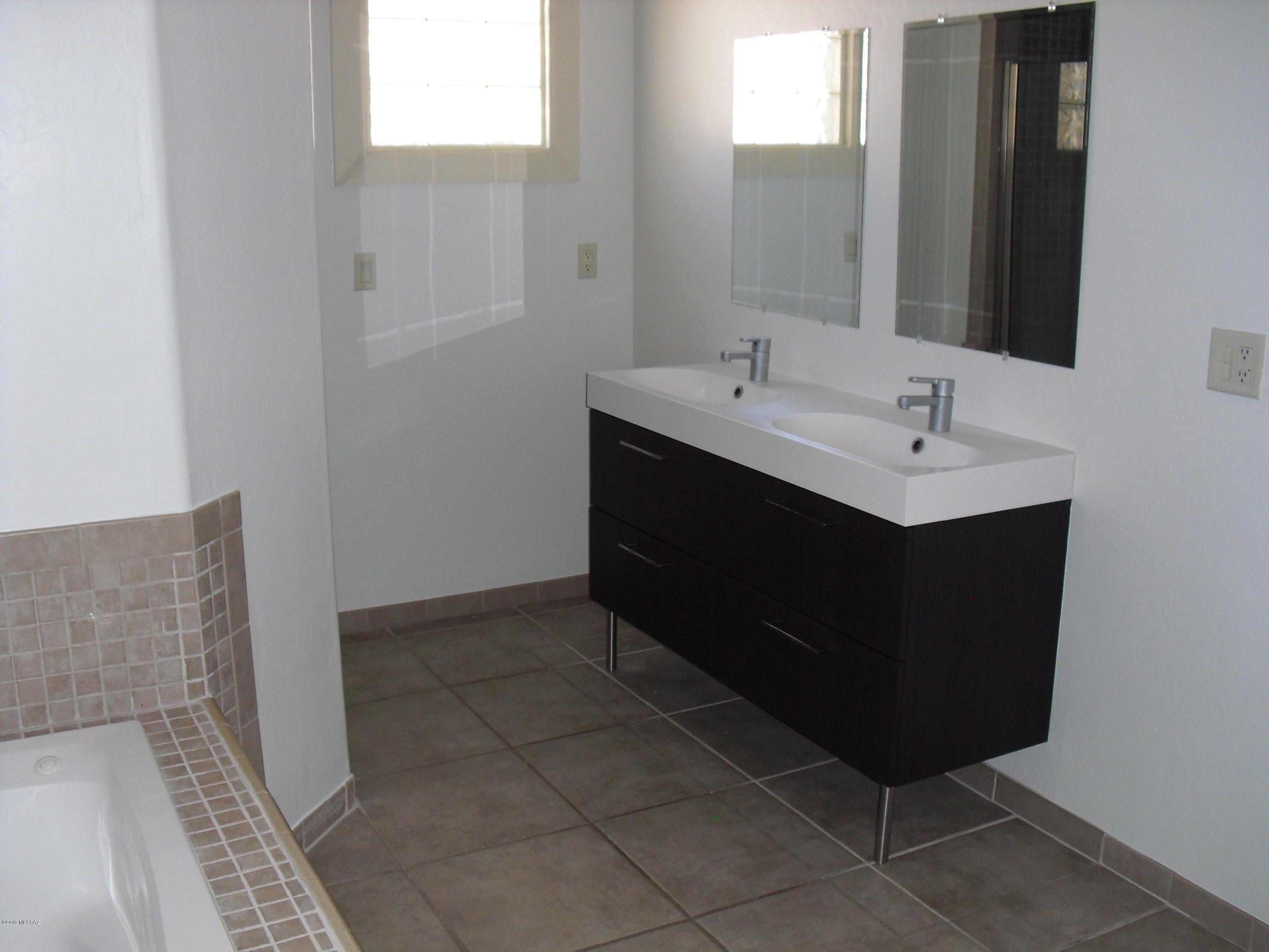 402 Hopkins Street Rio Rico, AZ 85648 - Photo 12 of 14 a bathroom with a sink and a mirror