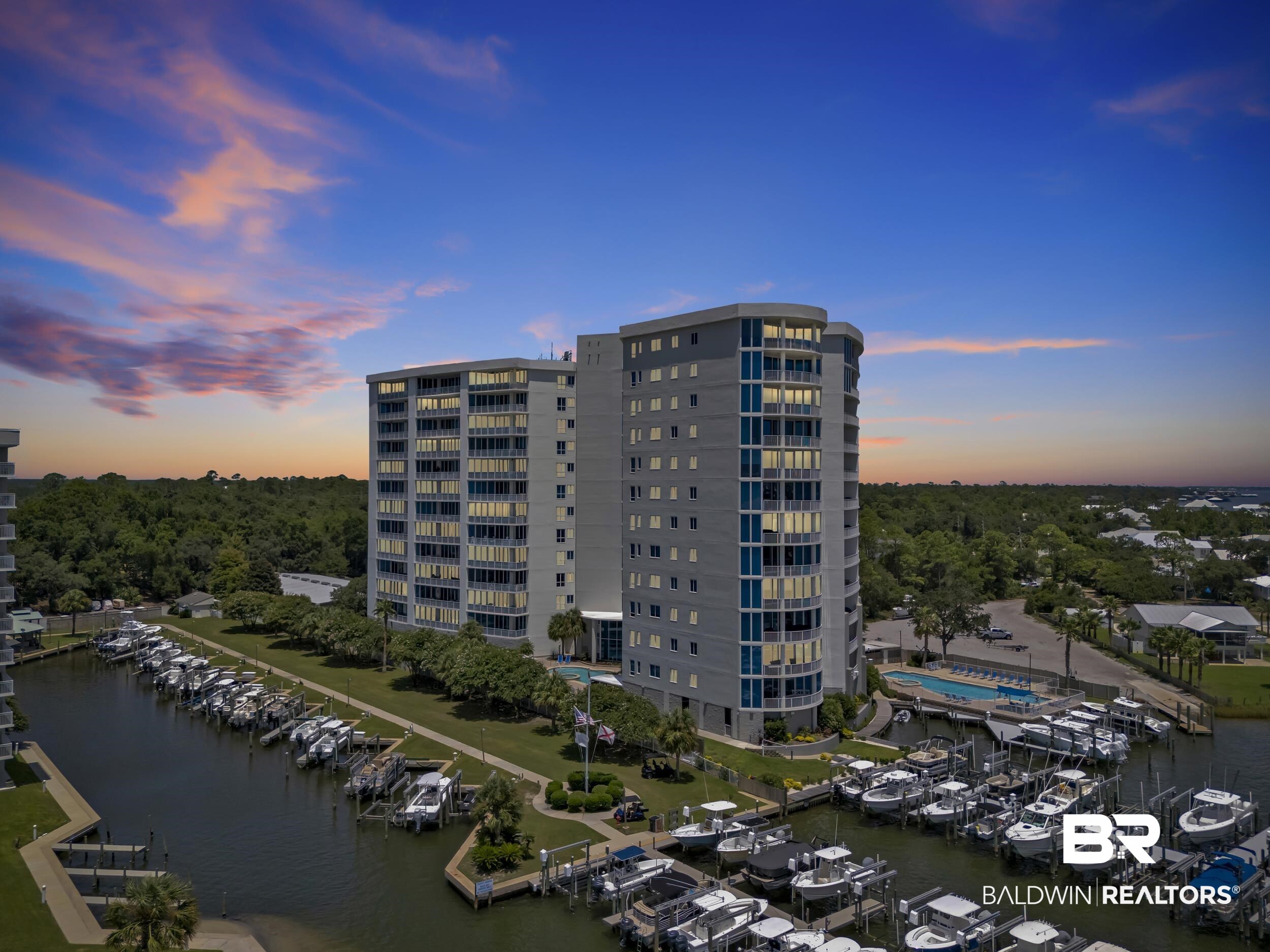 28250 Canal Road, Unit 307 Orange Beach, AL 36561 - Photo 55 of 56 Drone / aerial view of a nearby body of water and a marina