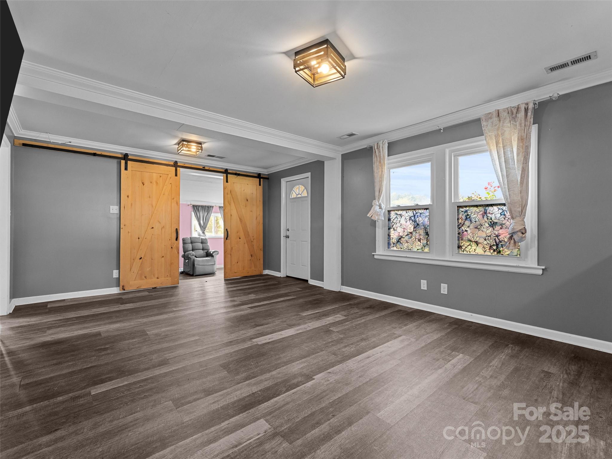 1148 North Ridge Road Hendersonville, NC 28792 - Photo 32 of 42 a view of empty room with wooden floor and fan
