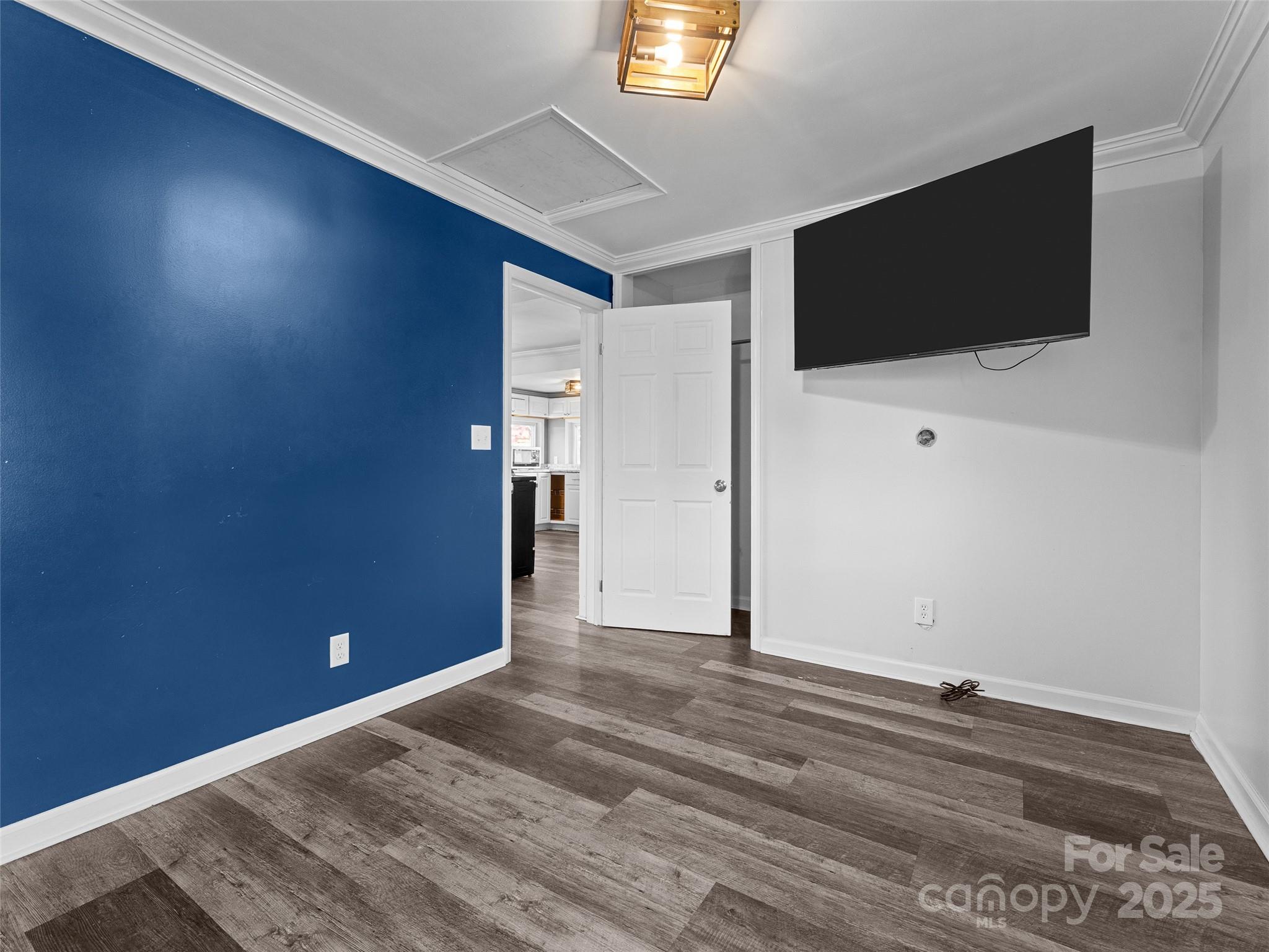 1148 North Ridge Road Hendersonville, NC 28792 - Photo 37 of 42 a view of a livingroom with an empty space and a flat screen tv