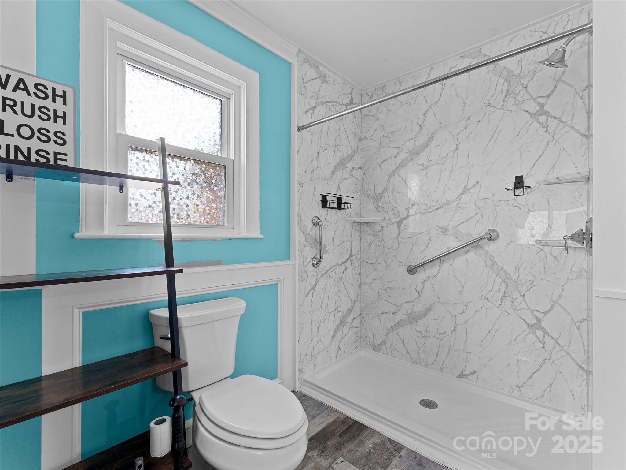 1148 North Ridge Road Hendersonville, NC 28792 - Photo 40 of 42 a white toilet sitting next to a shower