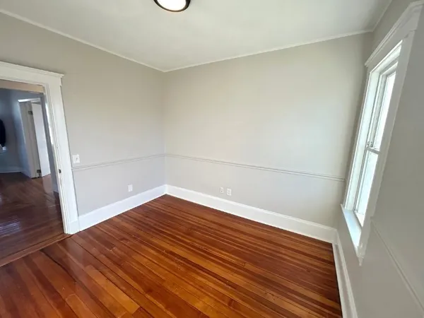 a view of wooden floor in an empty room