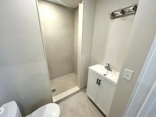 a bathroom with a sink toilet and shower