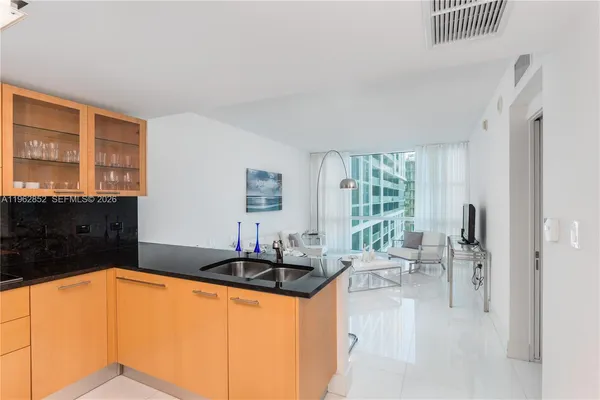 a kitchen with granite countertop a sink and a stove top oven
