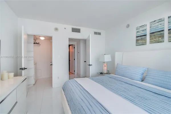 a bedroom with a bed and a couch