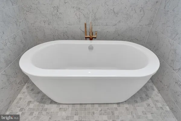a white bath tub sitting in a bathroom