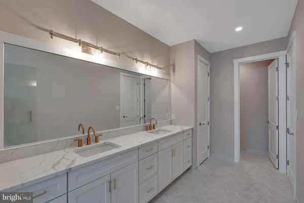 a bathroom with double sink and a mirror