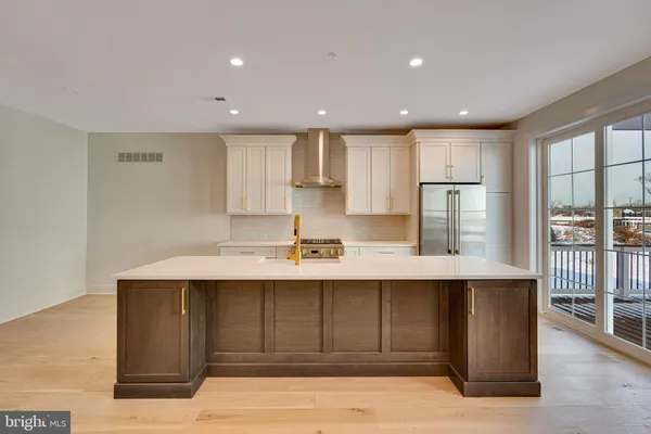 a kitchen with a sink stainless steel appliances and cabinets