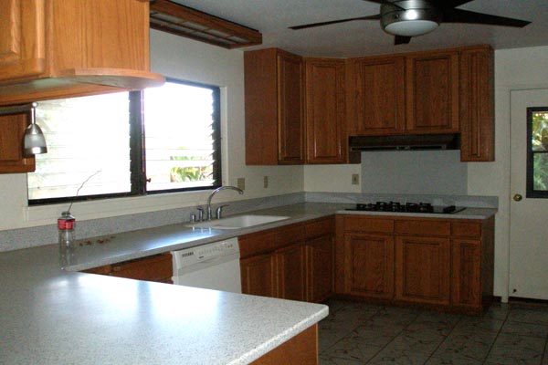 1291 Puuopae Road Kapaa, HI 96746 - Photo 12 of 25 a kitchen with stainless steel appliances granite countertop a sink window and cabinets