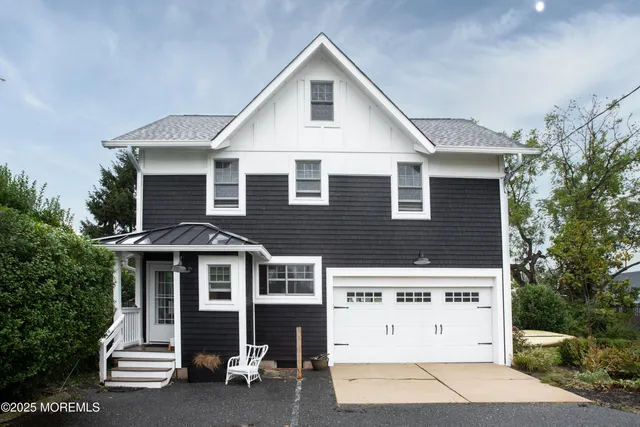 a view of a house with a yard and porch