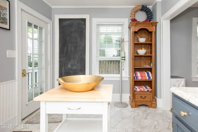 a dining room with a table and a potted plant