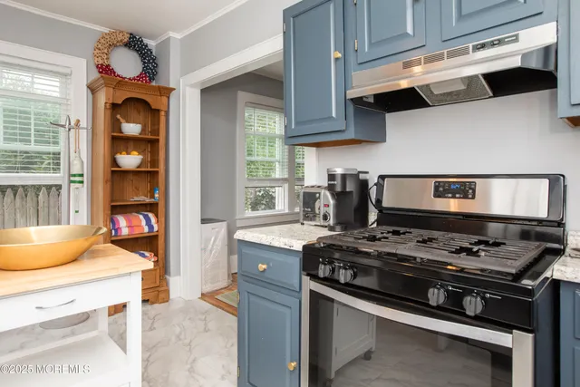 a kitchen with stainless steel appliances granite countertop a stove and a microwave