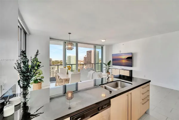 a kitchen with a counter space a sink and a window