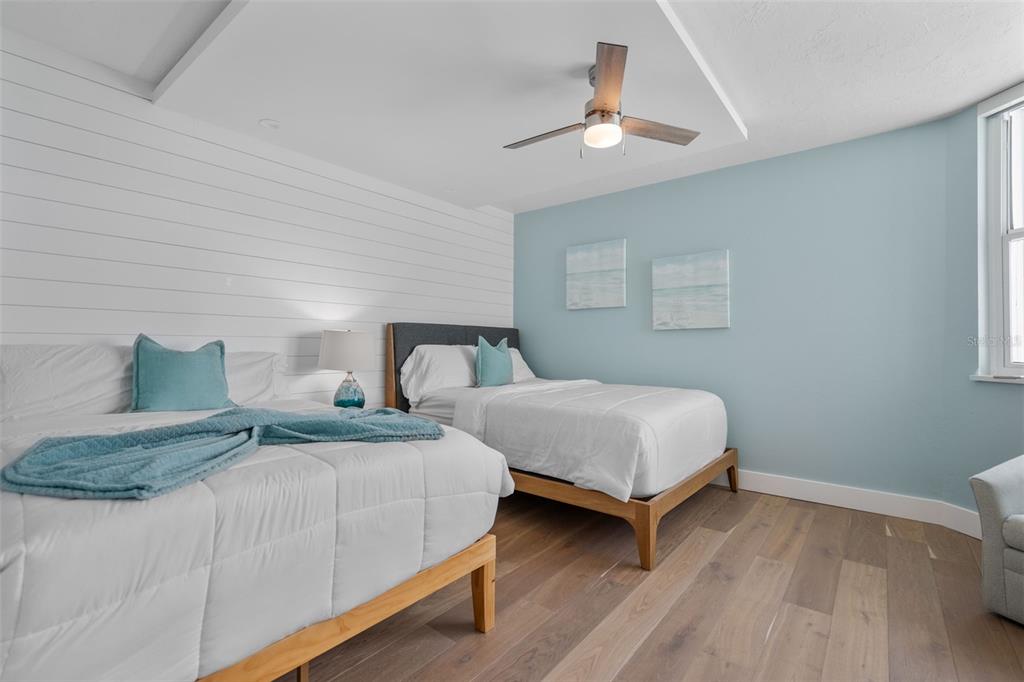 1050 Longboat Club Road, Unit 901 Longboat Key, FL 34228 - Photo 22 of 37 a bedroom with two beds and a chandelier