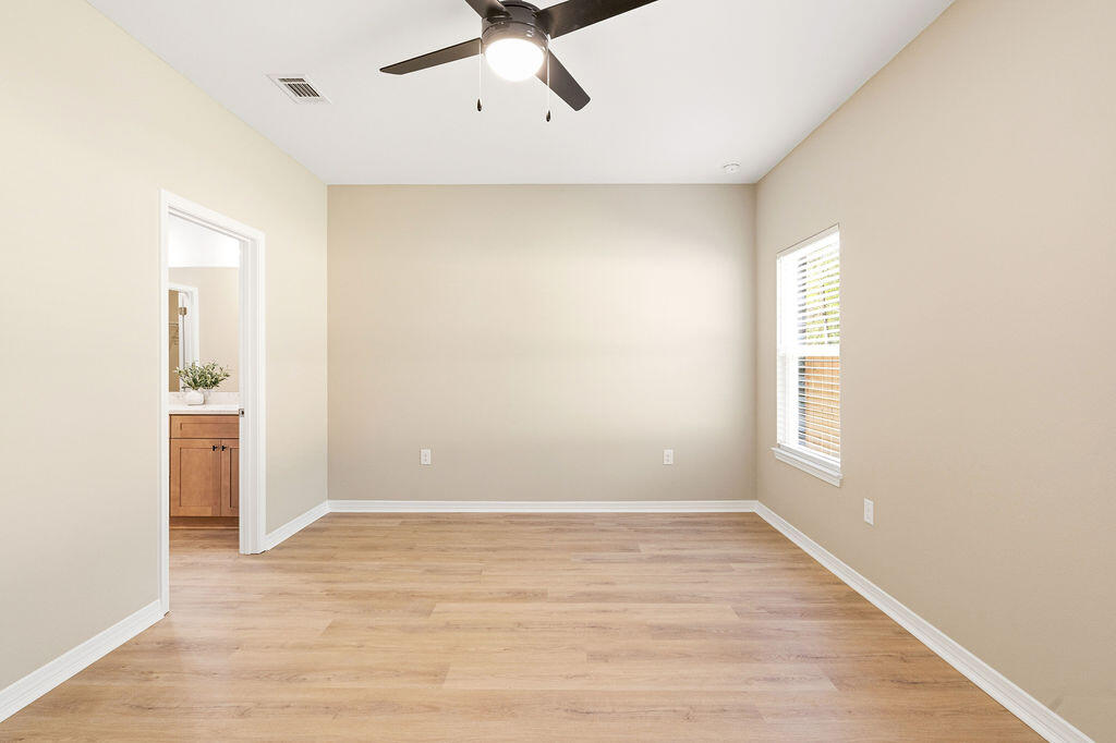 3810 Golden Acres Circle Crestview, FL 32539 - Photo 4 of 9 a view of an empty room with wooden floor and a window