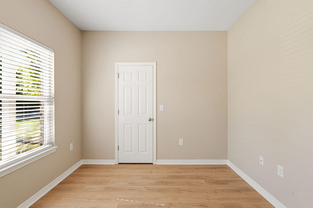 3810 Golden Acres Circle Crestview, FL 32539 - Photo 7 of 9 a view of an empty room with wooden floor and a window