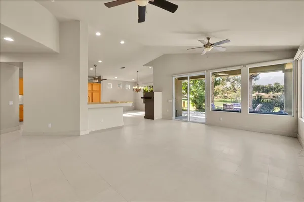 a kitchen with stainless steel appliances granite countertop a sink and a refrigerator