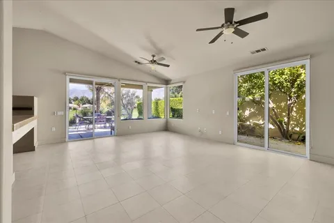 a view of an empty room with a fireplace and a large window