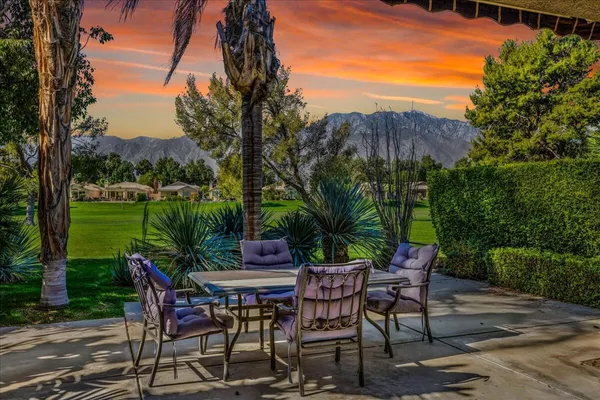 a view of a patio with table and chairs and potted plants