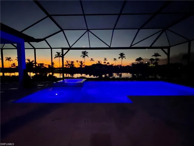 a large kitchen with cabinets and flat screen tv