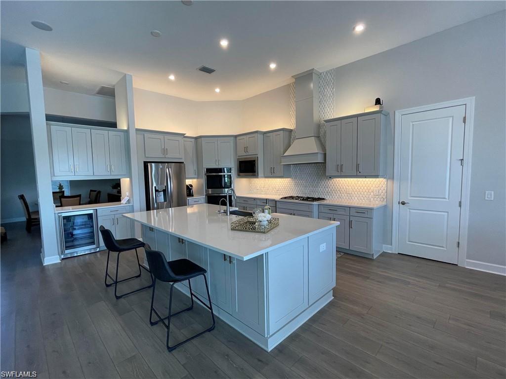 15587 Montello Lane Naples, FL 34114 - Photo 13 of 17 a kitchen with a sink cabinets and wooden floor