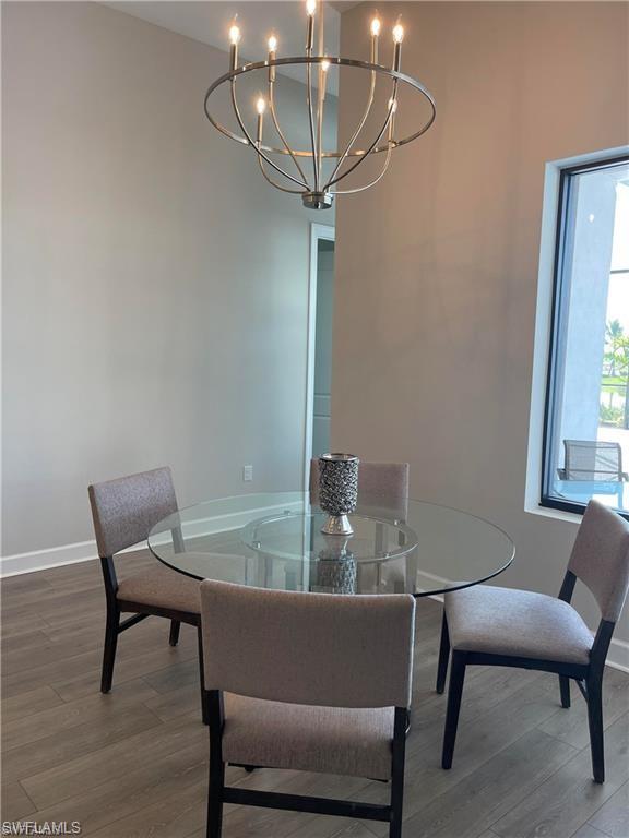 15587 Montello Lane Naples, FL 34114 - Photo 15 of 17 a view of a dining room with furniture and window