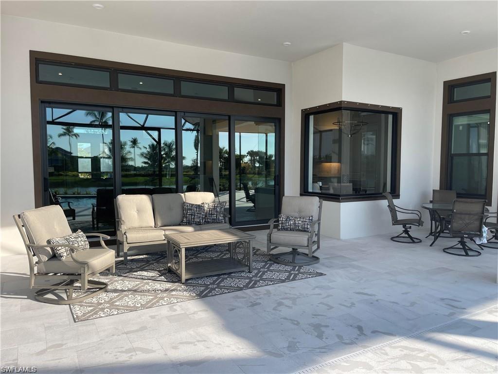 15587 Montello Lane Naples, FL 34114 - Photo 4 of 17 a living room with furniture and large windows