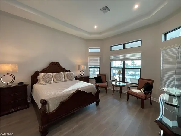 a bedroom with a bed a couch and a window