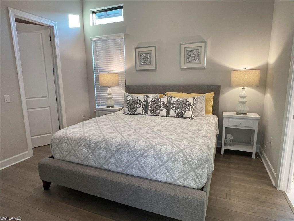 15587 Montello Lane Naples, FL 34114 - Photo 7 of 17 a bedroom with a bed and a lamp