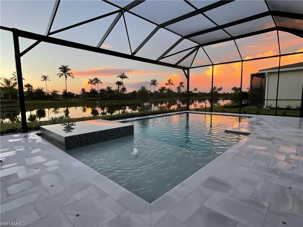 15587 Montello Lane Naples, FL 34114 - Photo 10 of 17 a view of swimming pool with a lounge chairs