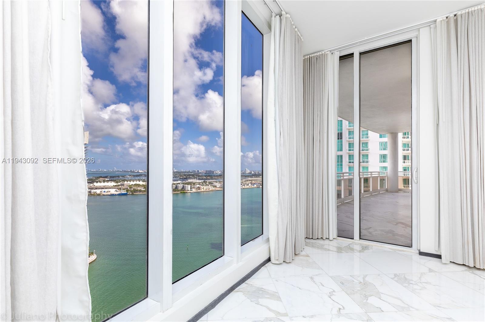 901 Brickell Key Boulevard, Unit 3407 Miami, FL 33131 - Photo 11 of 44 a view of a bathroom from a glass door