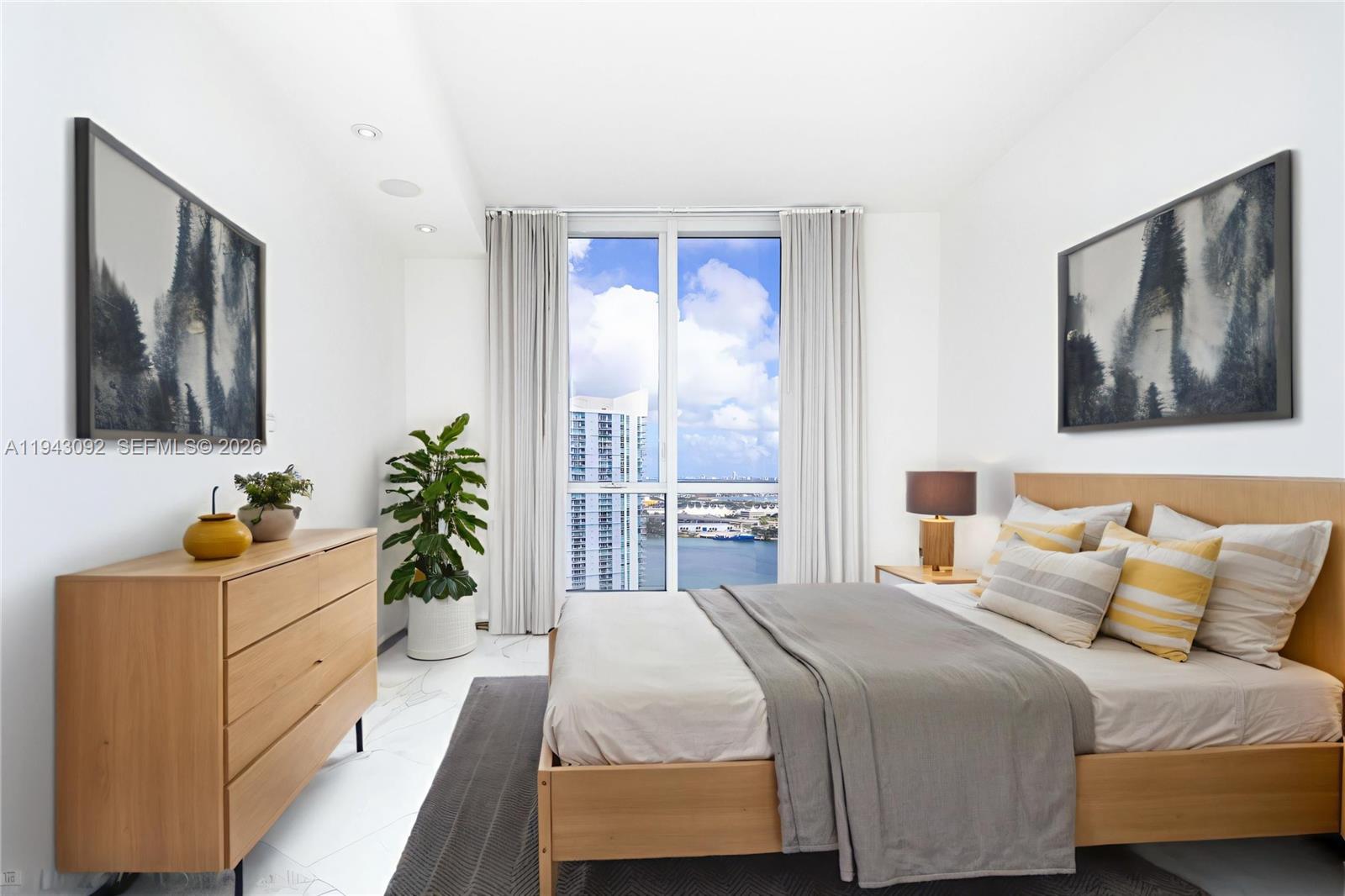 901 Brickell Key Boulevard, Unit 3407 Miami, FL 33131 - Photo 17 of 44 a bedroom with a bed and a painting on the wall