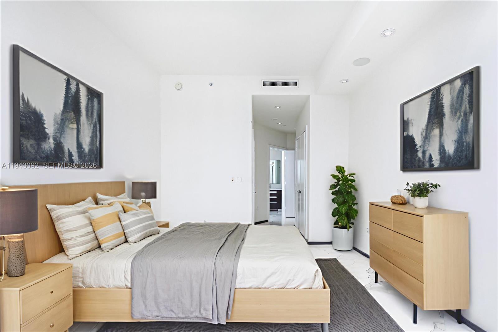 901 Brickell Key Boulevard, Unit 3407 Miami, FL 33131 - Photo 18 of 44 a bedroom with a bed and a couch