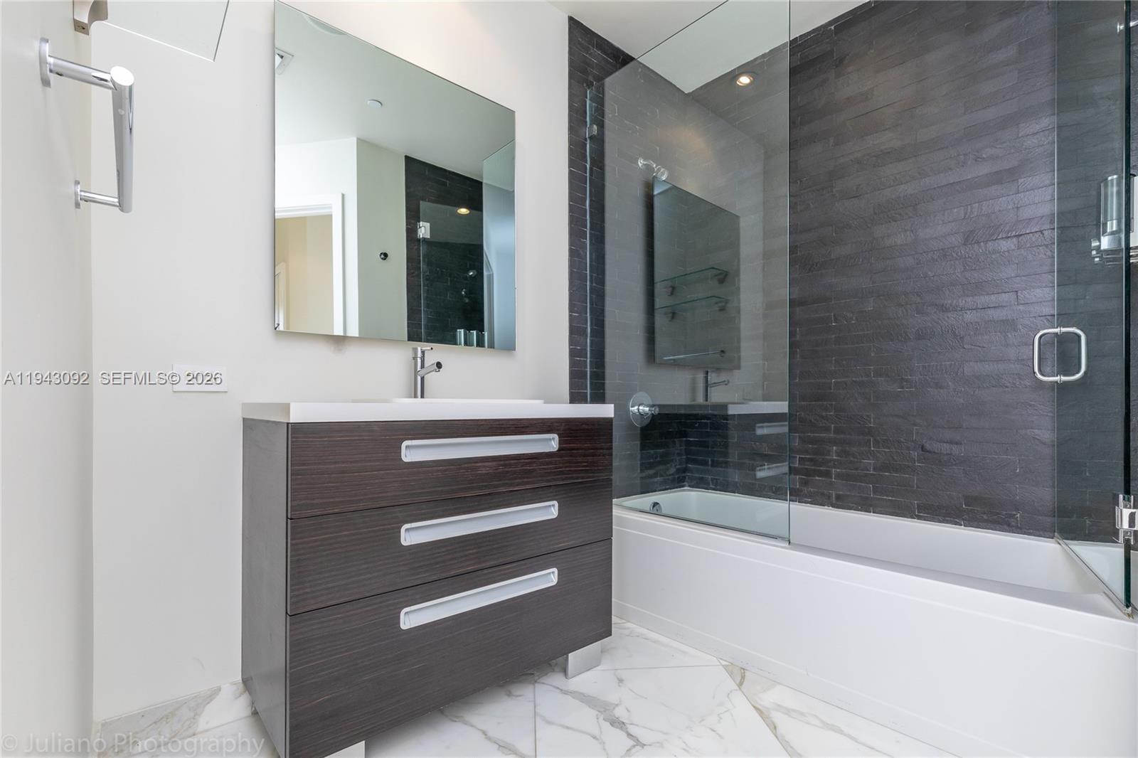 901 Brickell Key Boulevard, Unit 3407 Miami, FL 33131 - Photo 22 of 44 a bathroom with a bathtub and a sink
