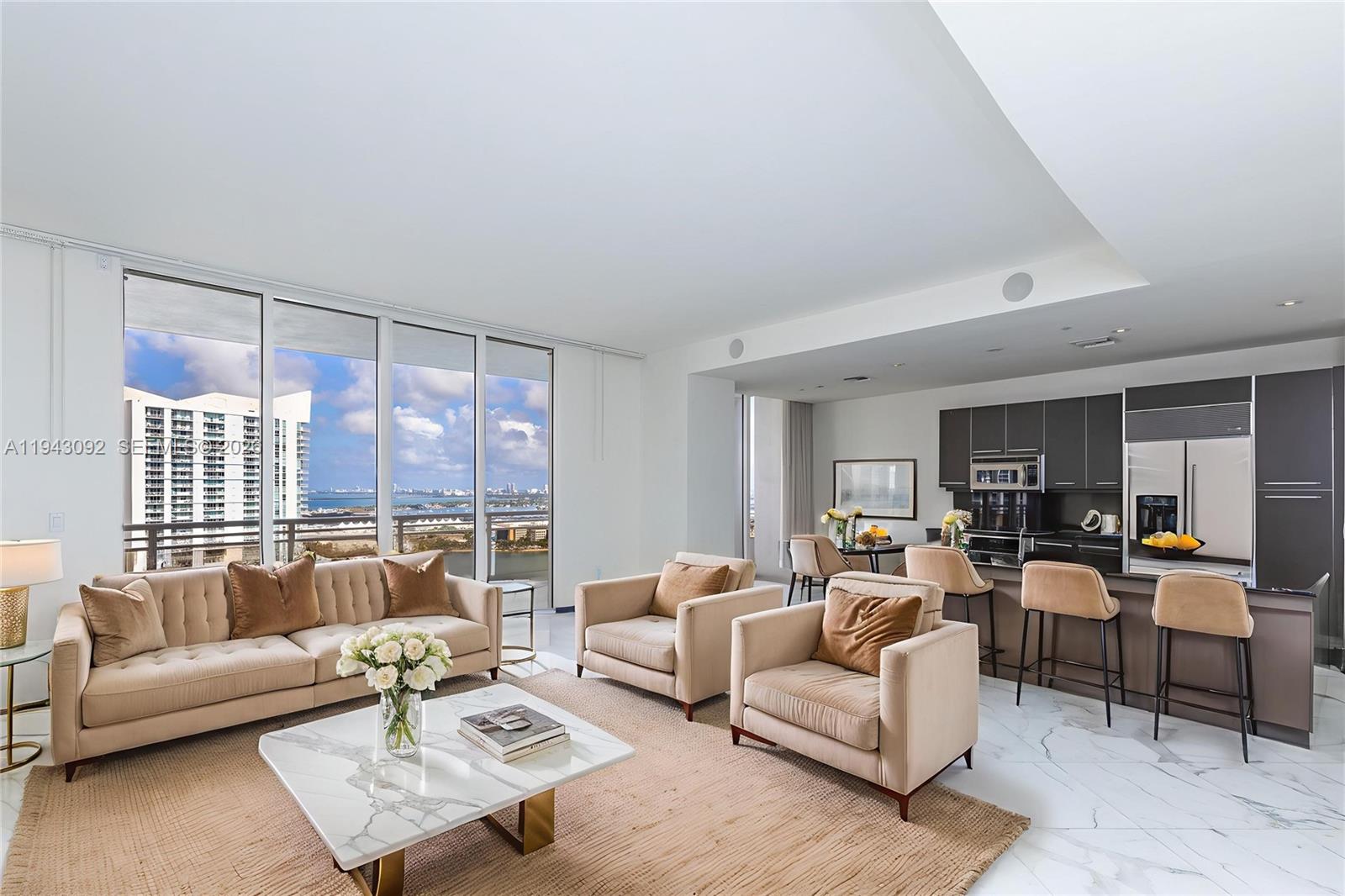 901 Brickell Key Boulevard, Unit 3407 Miami, FL 33131 - Photo 3 of 44 a living room with furniture and a large window