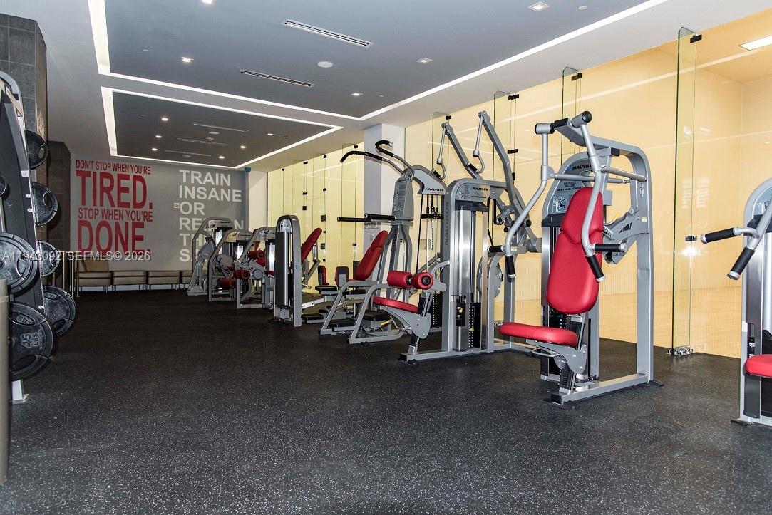 901 Brickell Key Boulevard, Unit 3407 Miami, FL 33131 - Photo 31 of 44 a view of a room with gym equipment
