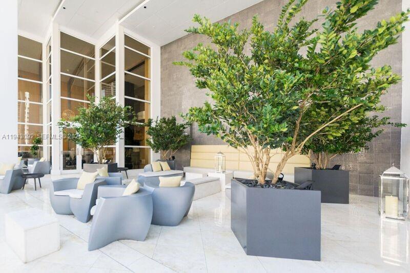 901 Brickell Key Boulevard, Unit 3407 Miami, FL 33131 - Photo 37 of 44 a view of a patio with couches and potted plants