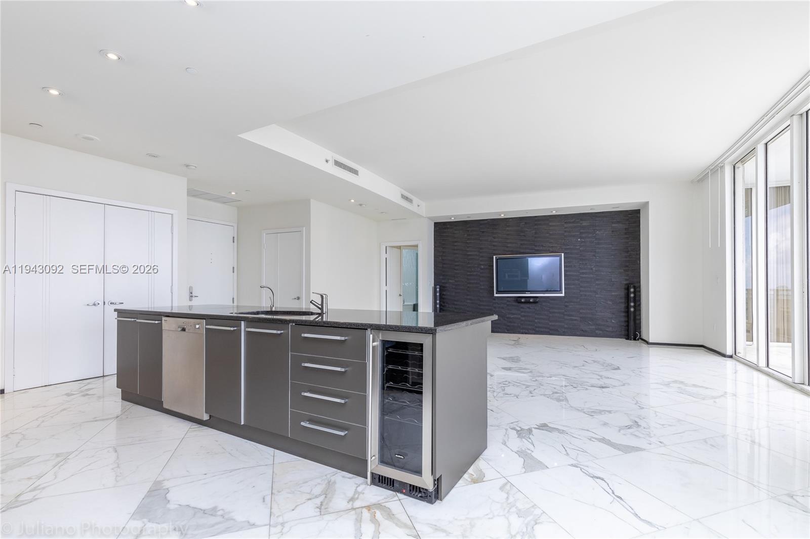 901 Brickell Key Boulevard, Unit 3407 Miami, FL 33131 - Photo 6 of 44 a large kitchen with stainless steel appliances granite countertop a stove and a sink