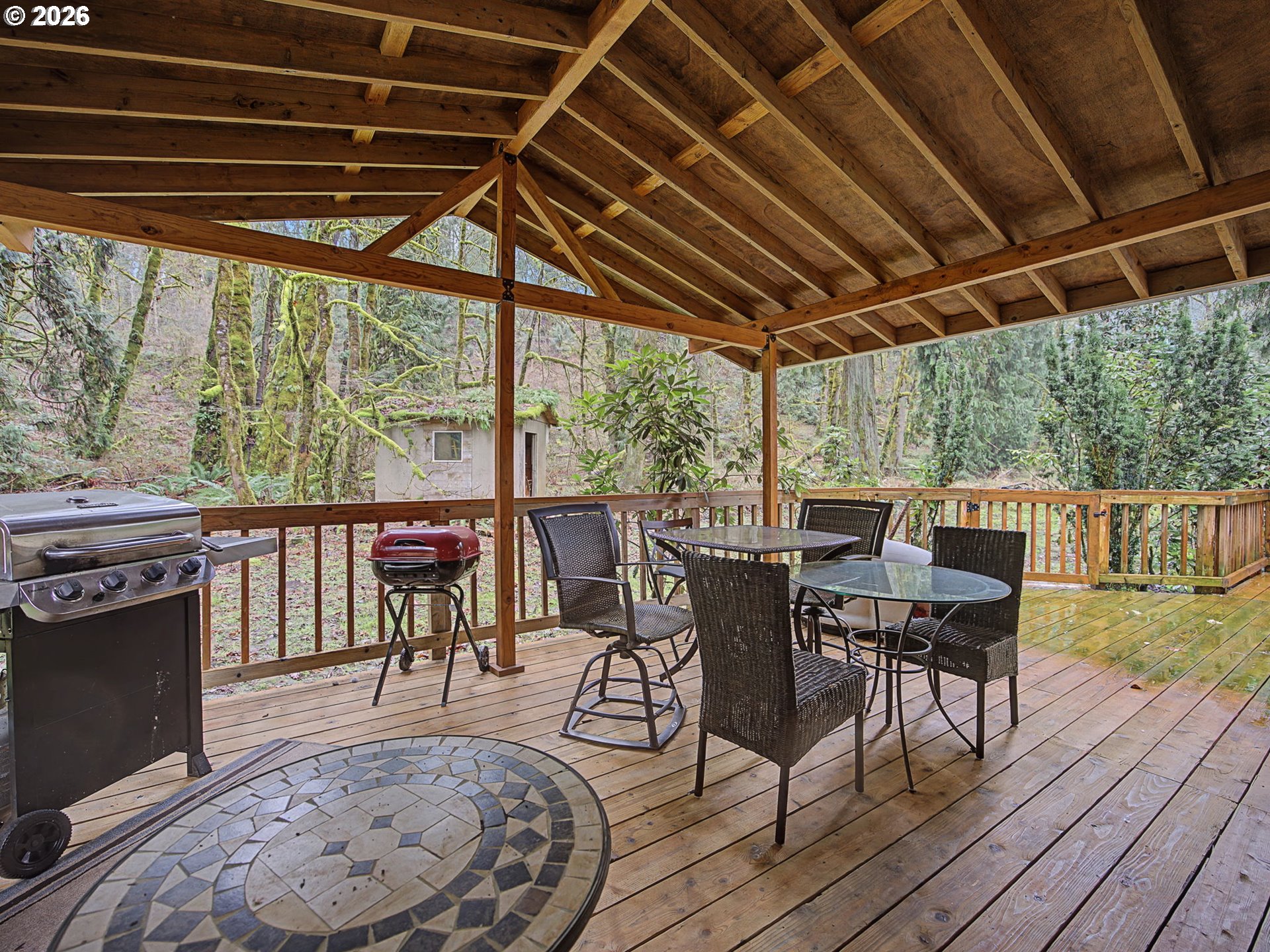 41180 Southeast Kubitz Road Sandy, OR 97055 - Photo 15 of 35 a view of a patio with wooden floor a barbeque grill with table and chairs