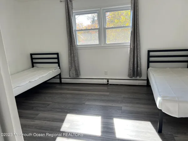 a view of room with wooden floor and window