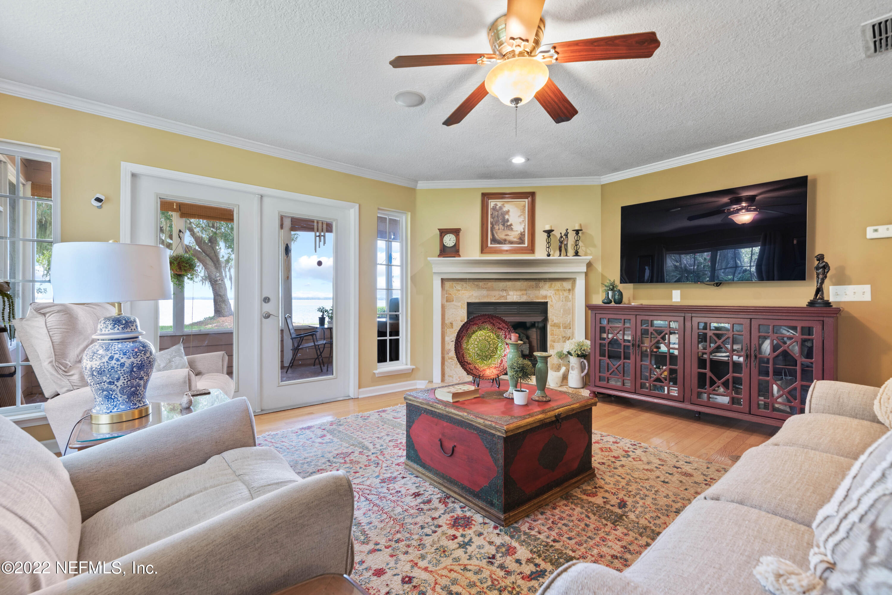 5345 Pine Avenue Fleming Island, FL 32003 - Photo 12 of 39 a living room with furniture a flat screen tv and a fireplace