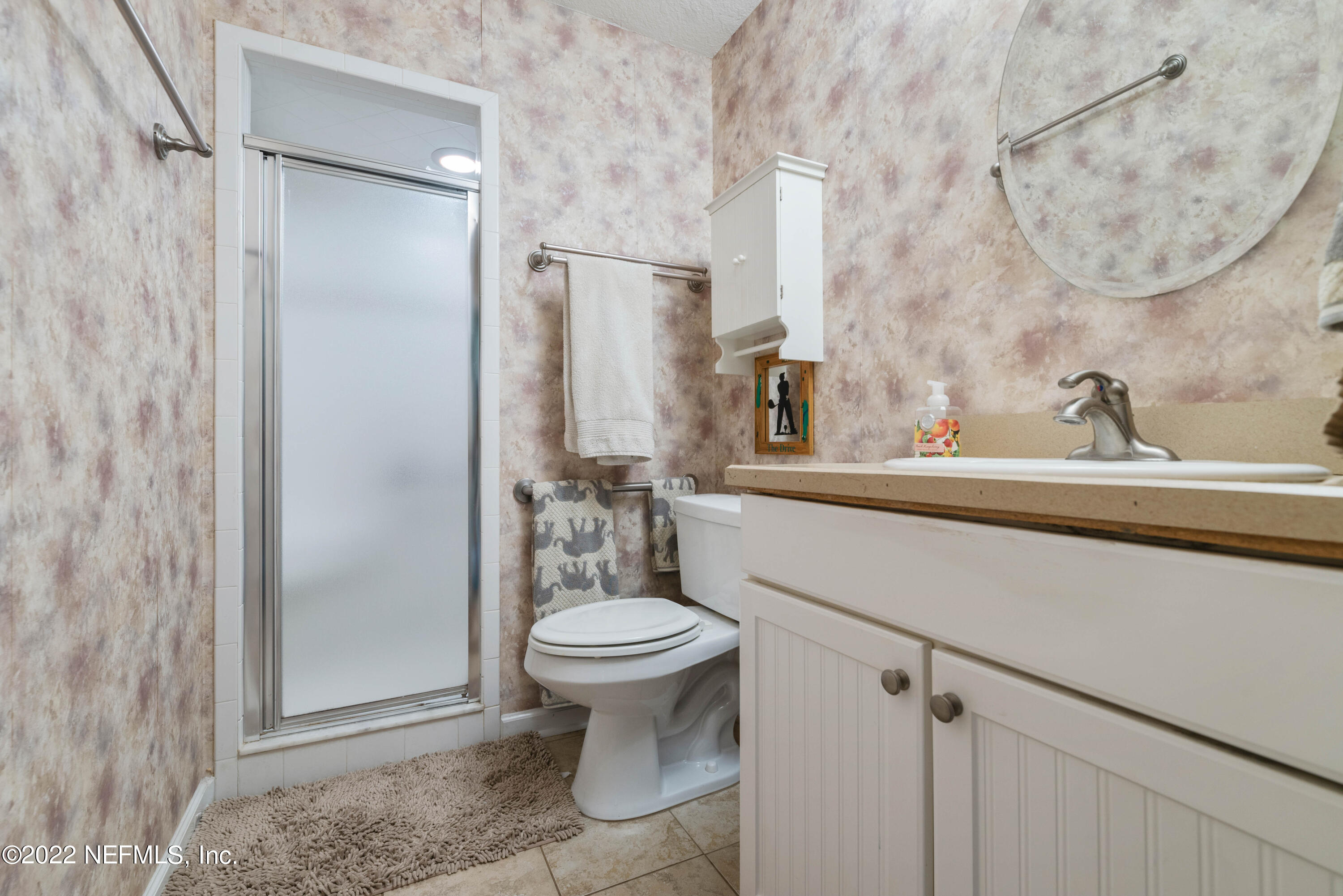 5345 Pine Avenue Fleming Island, FL 32003 - Photo 19 of 39 a bathroom with a sink toilet and shower