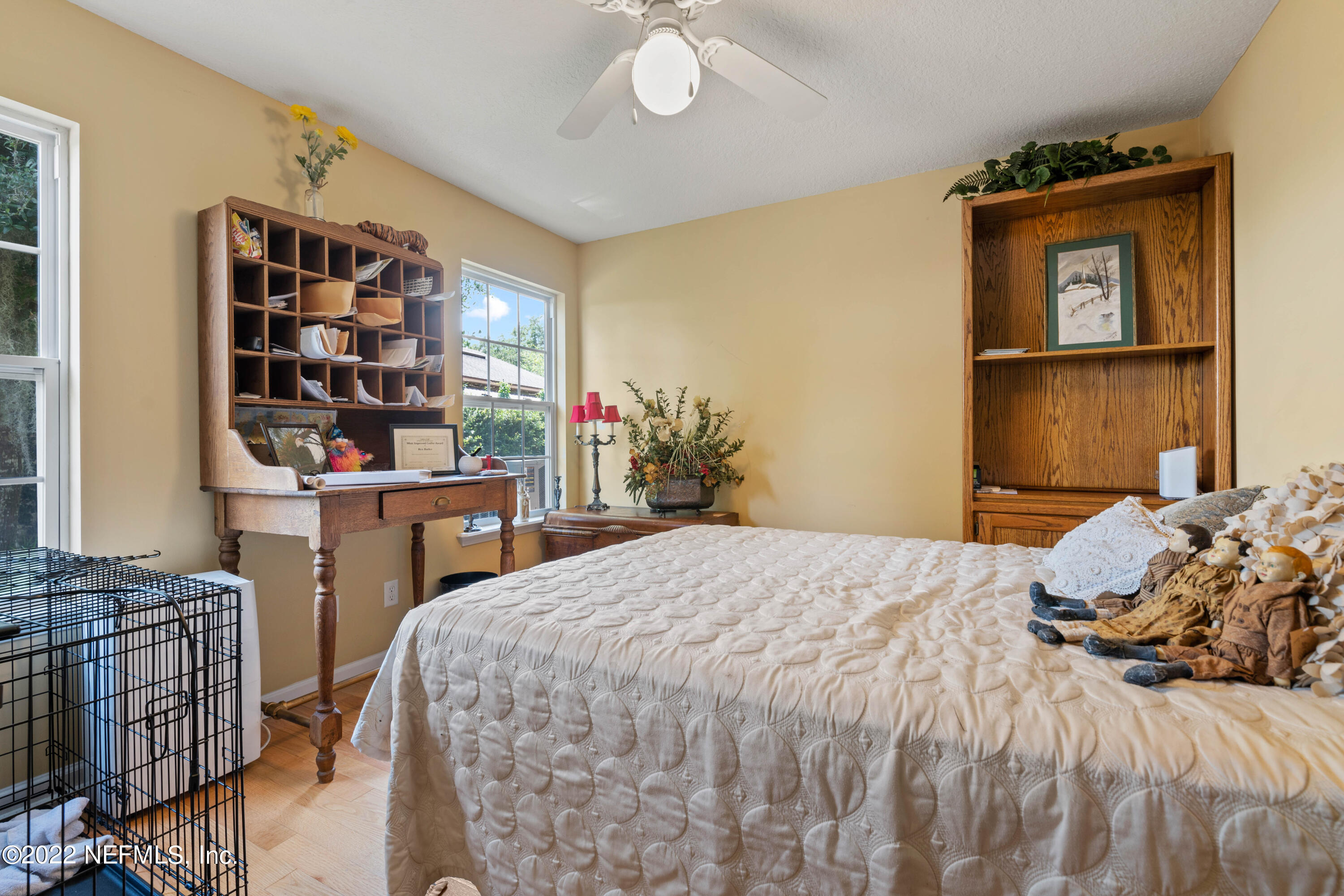 5345 Pine Avenue Fleming Island, FL 32003 - Photo 20 of 39 a bedroom that has a bed and a bookshelf in it
