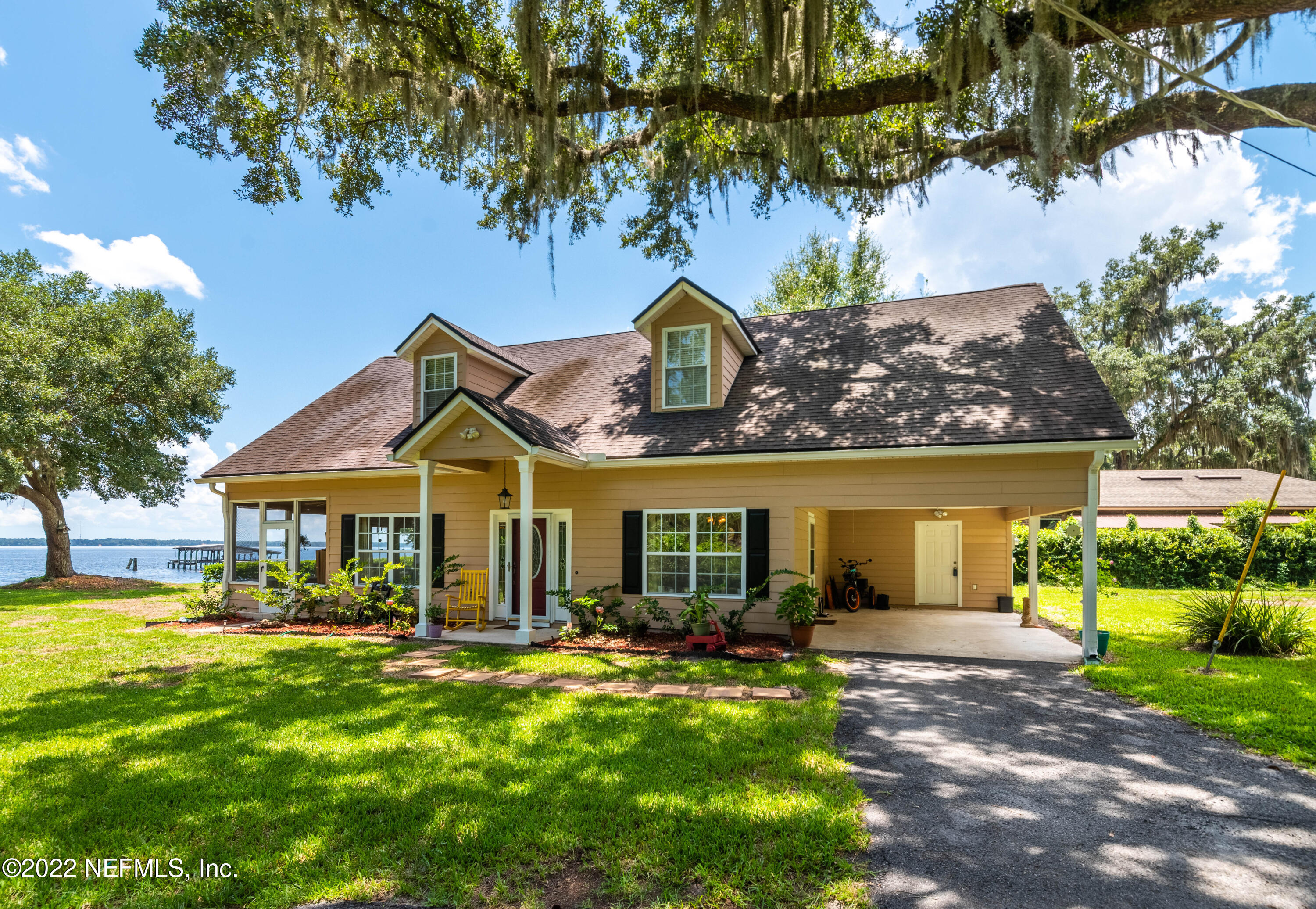 5345 Pine Avenue Fleming Island, FL 32003 - Photo 2 of 39 a front view of a house with garden